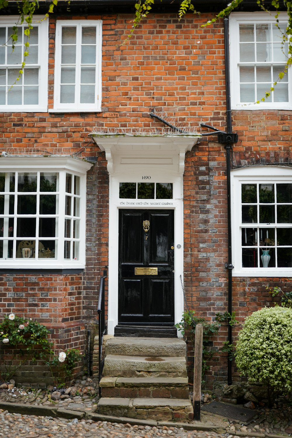 a brick building with a black door