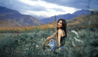 a person sitting in a field of flowers