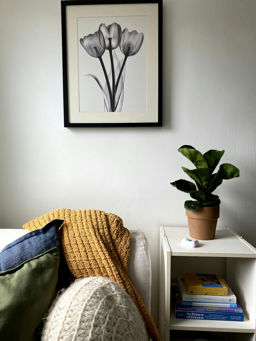 a room filled with furniture and vase of flowers sitting on a bed