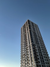 A designer sketching a modern residential building plan on a digital tablet.