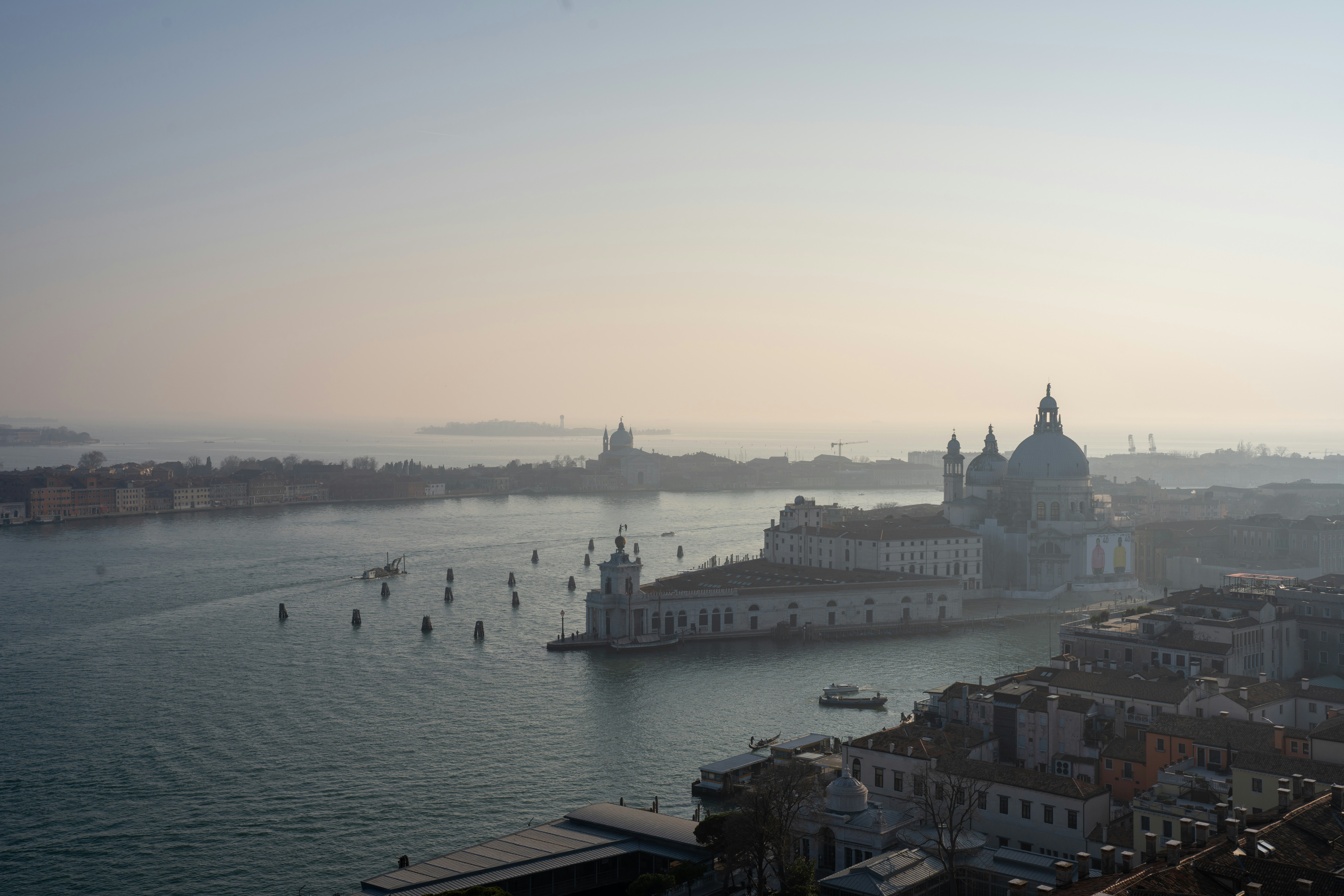 a body of water with buildings and boats in it, Skyline view from St. Mark