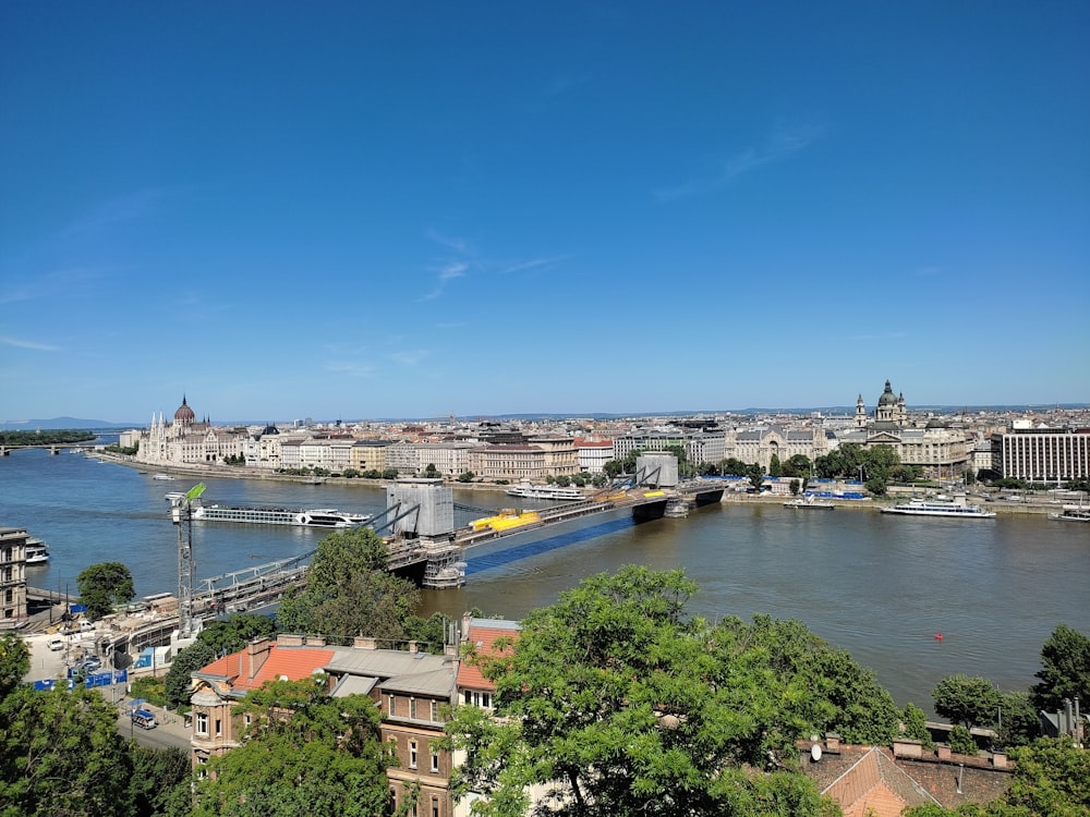 a bridge over a river with buildings and trees on the side