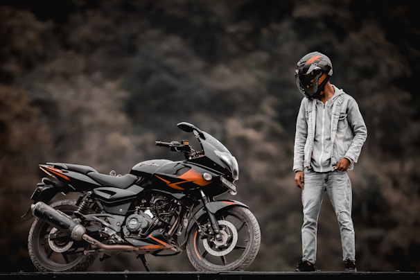 a man standing next to a motorcycle