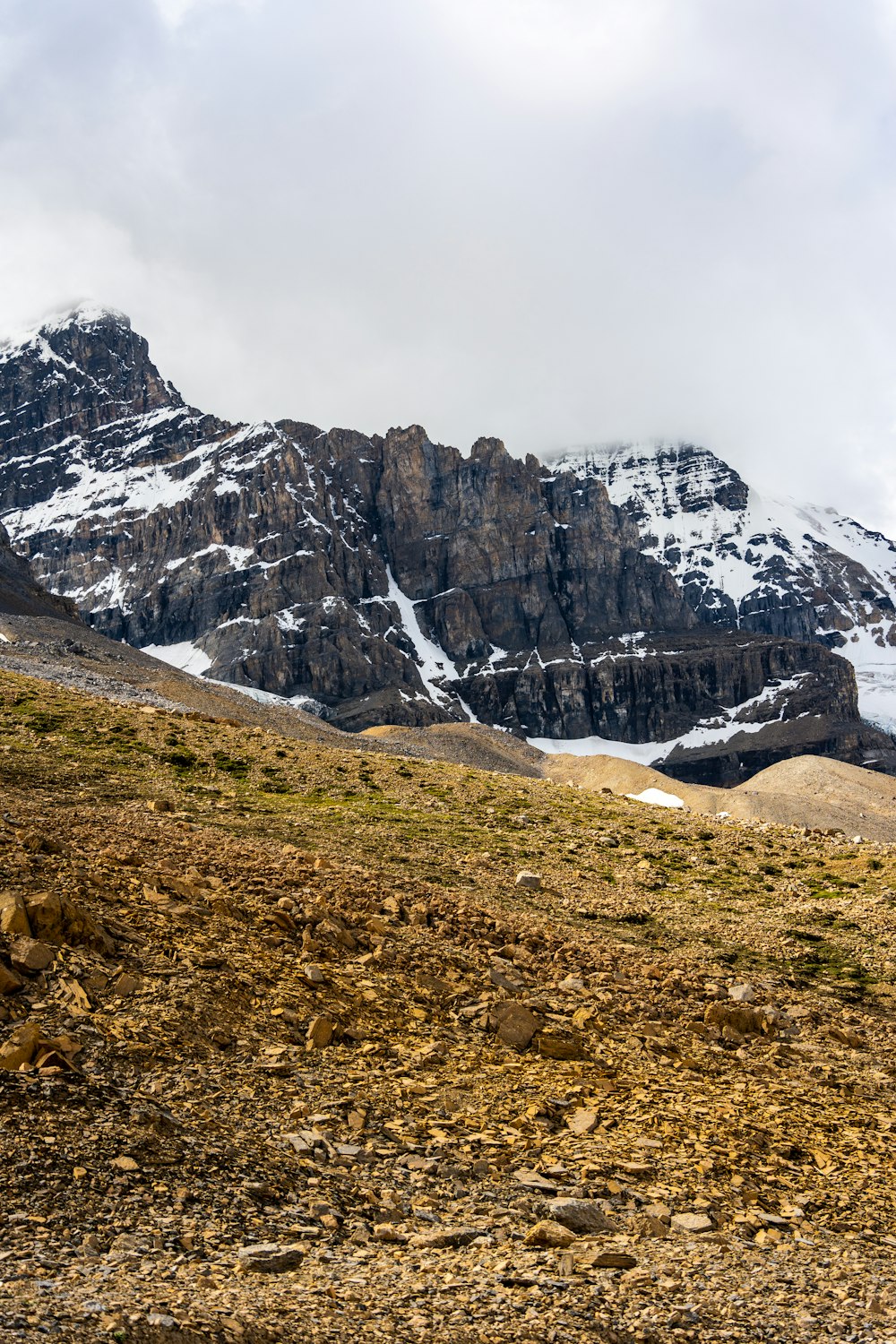 a rocky mountain with snow