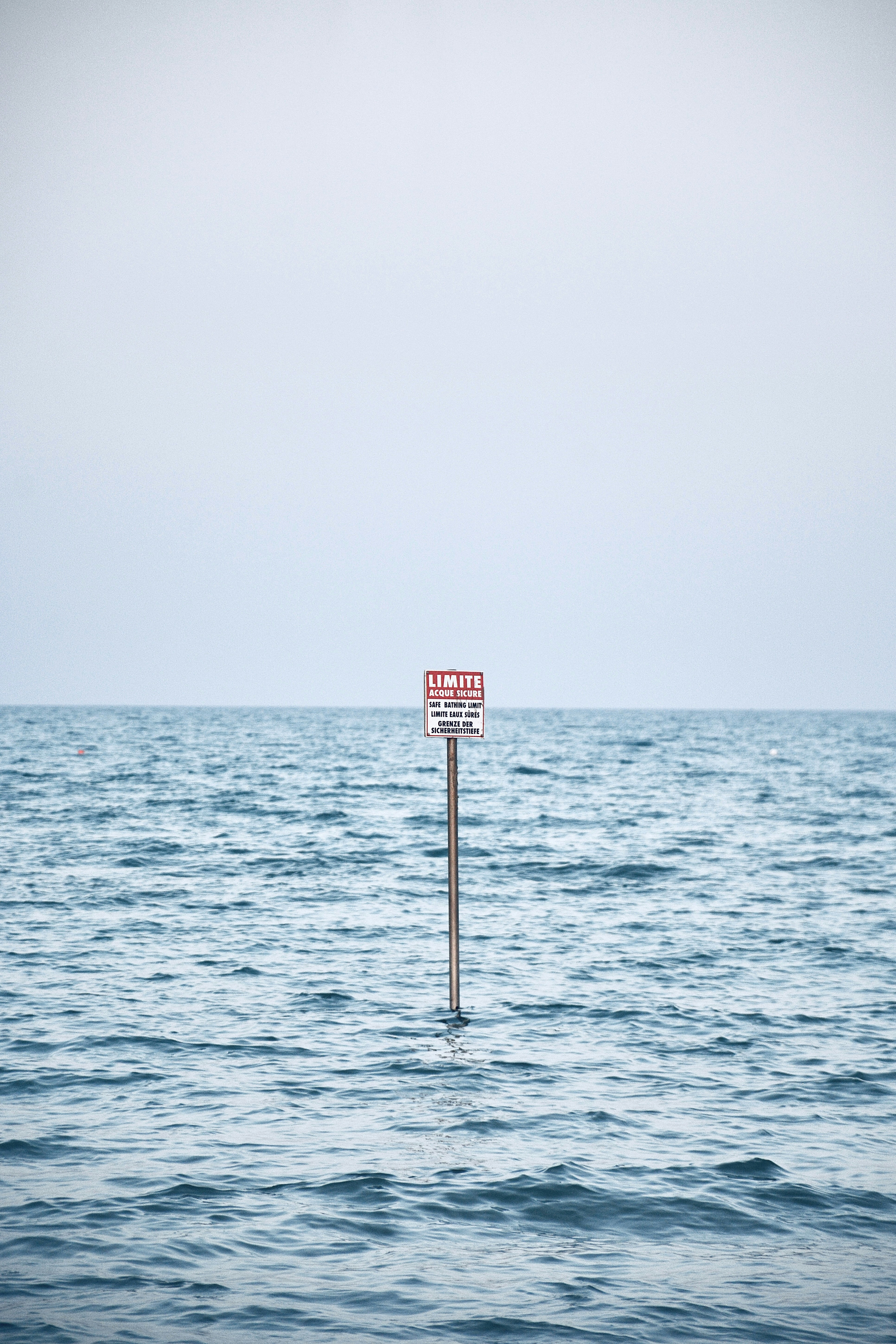a sign in the middle of the ocean