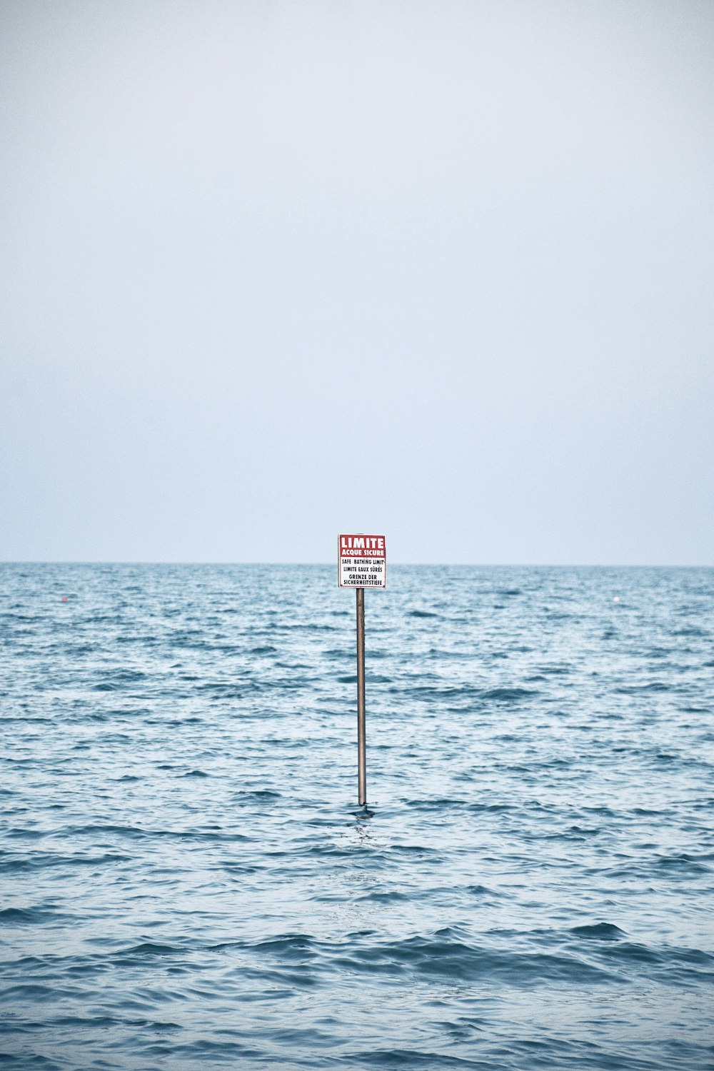 a sign in the middle of the ocean