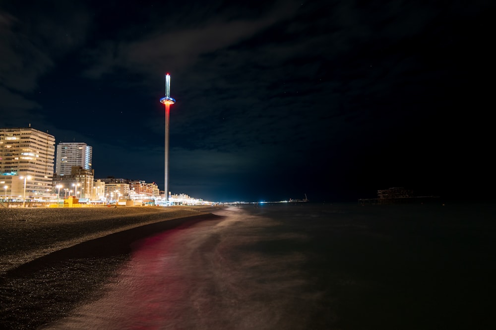 a tall tower in the middle of a road at night