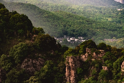 Visualization of an ancient Indigenous settlement with longhouses and surrounding forest in vibrant colors.