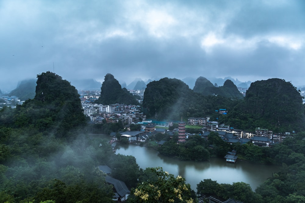 a river with a city and mountains in the background