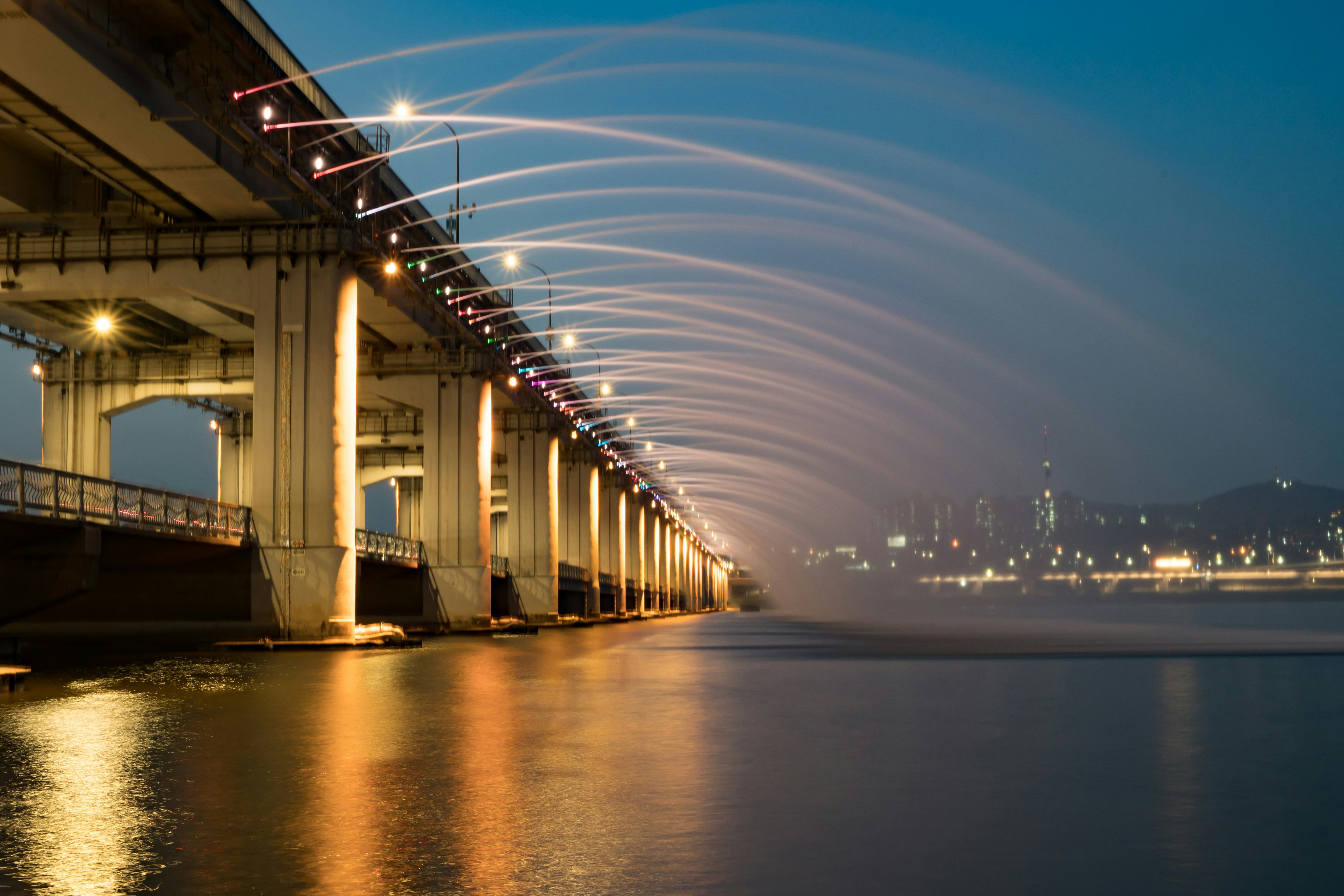 a bridge with lights on at night, 