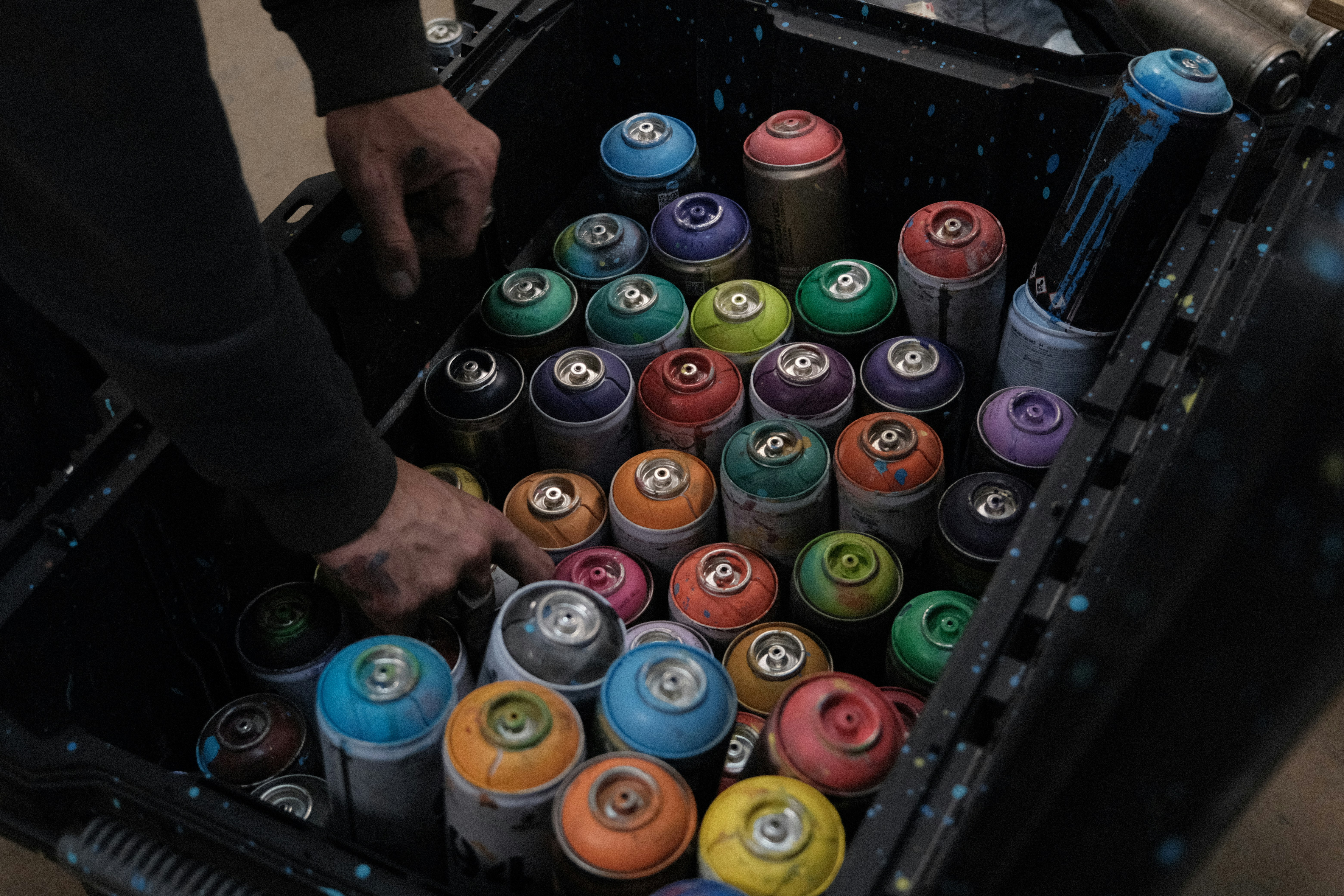 a person holding a stack of cans