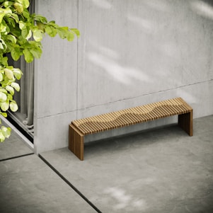 a bench next to a plant
