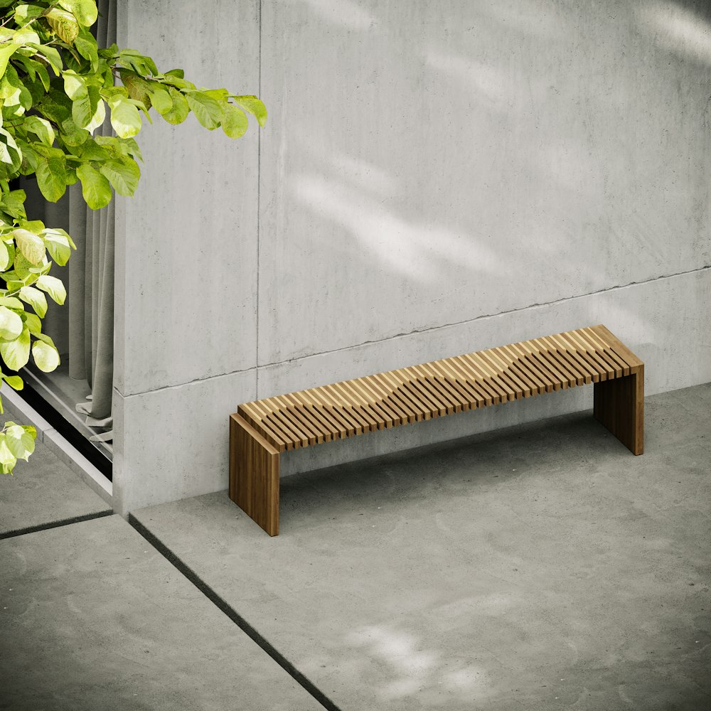 a bench next to a plant