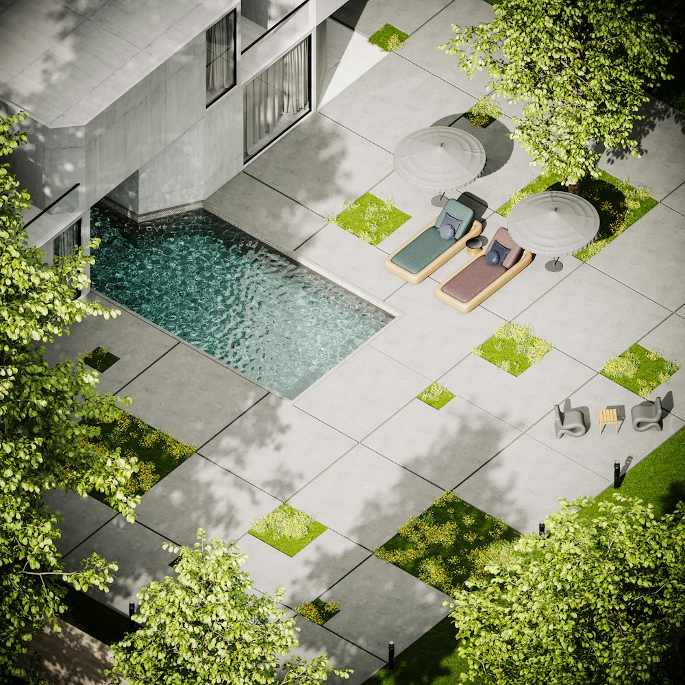 a courtyard with a pool and chairs