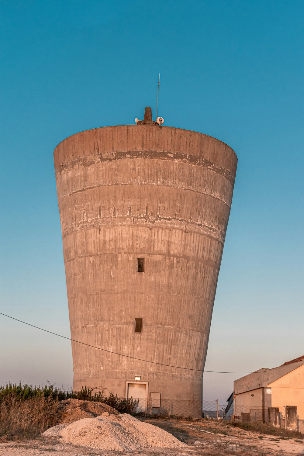 a large tower with a fence around it