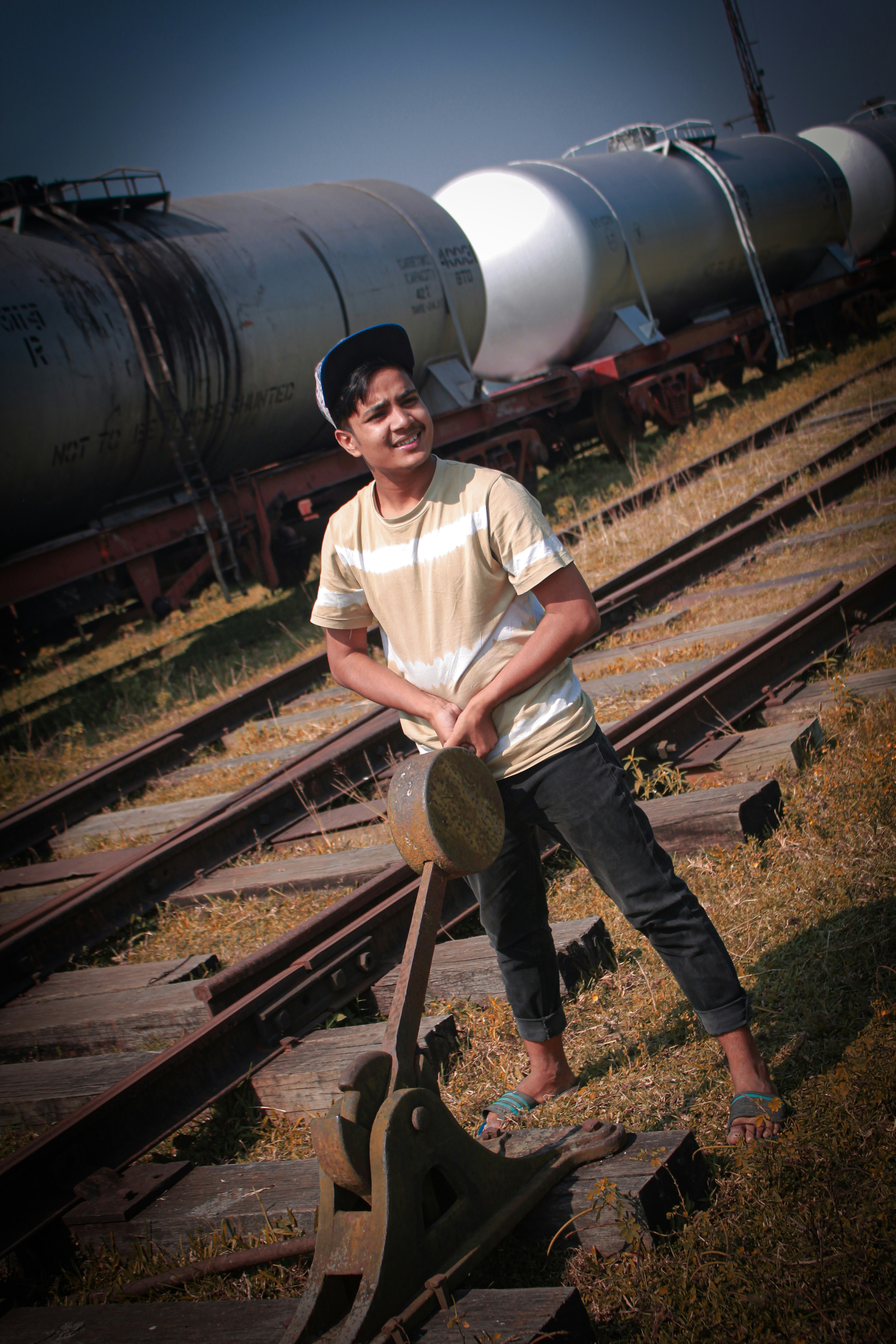 a man sitting on train tracks