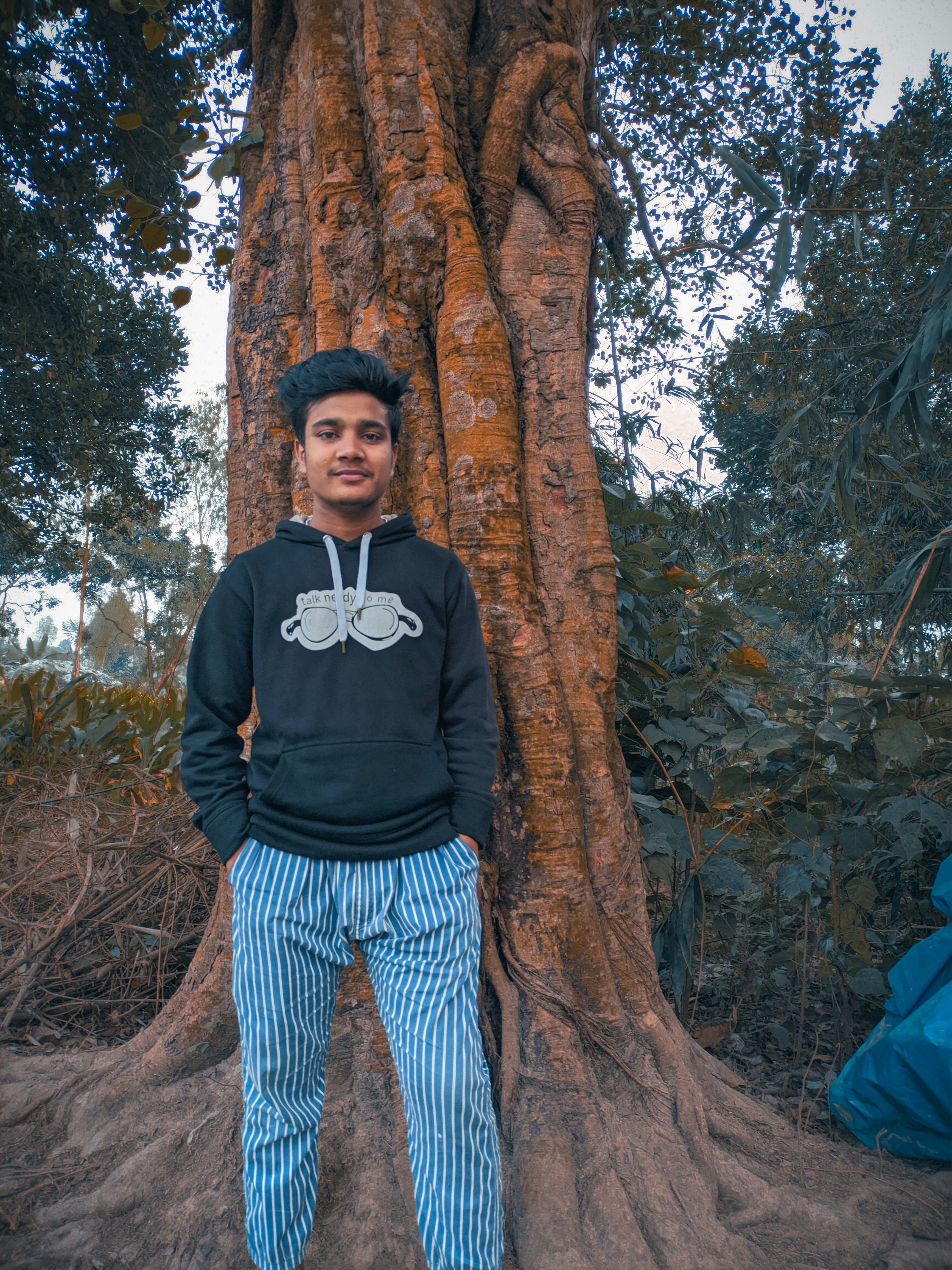 a person standing next to a tree