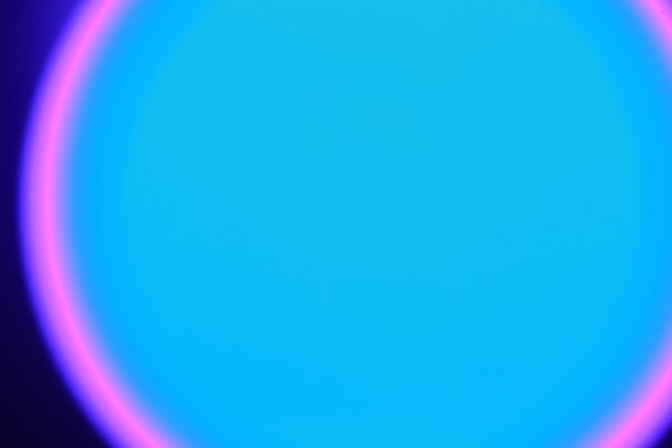 Pulsating badge with green and blue neon glow on dark backdrop