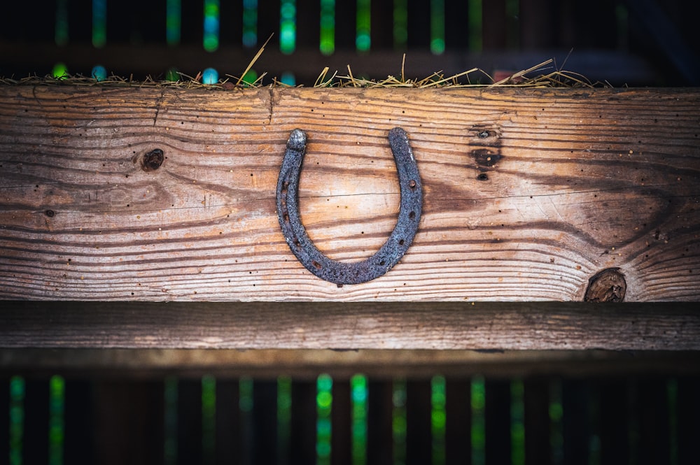 a wooden fence with a metal symbol