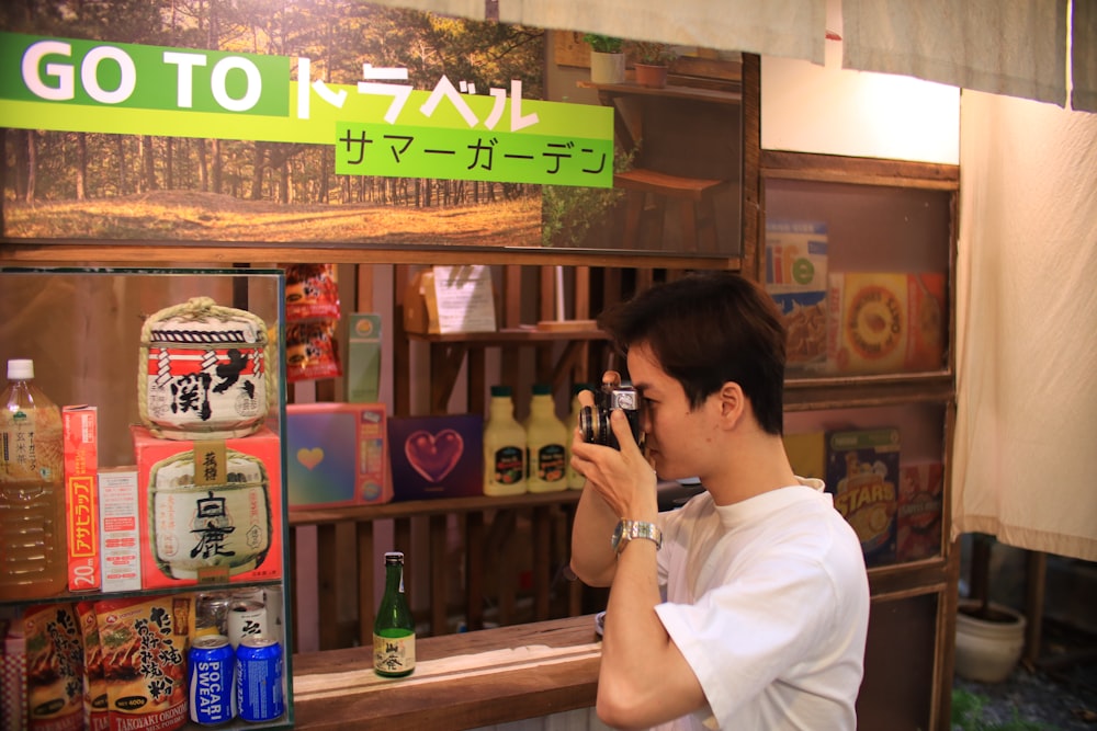 a woman taking a picture of a man in a restaurant