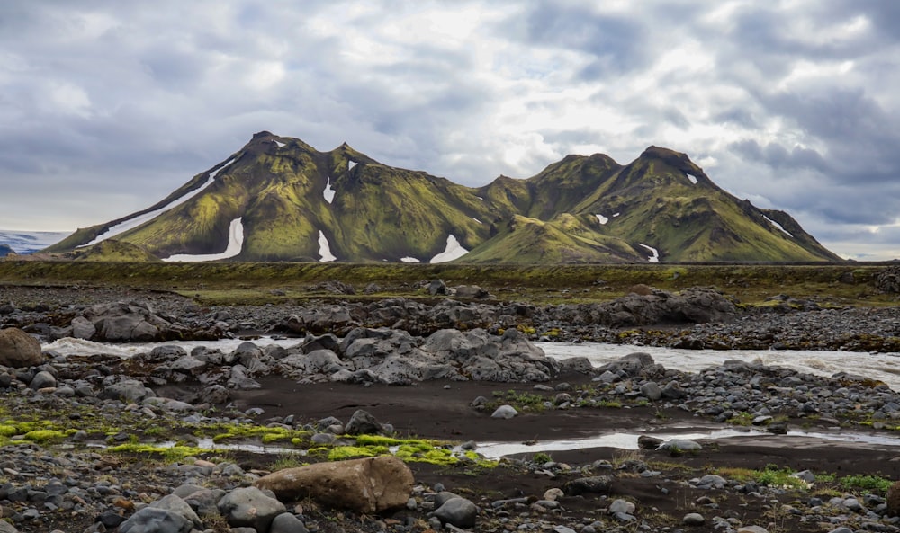 a rocky landscape with a mountain in the background