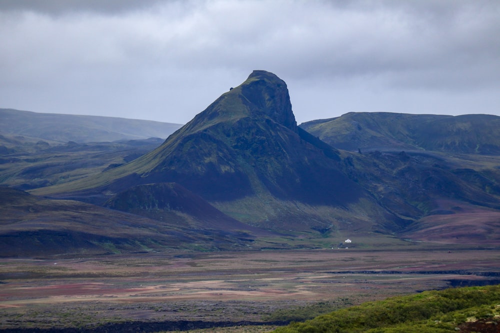 a large mountain with a valley below