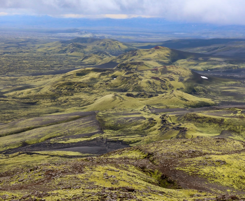 a landscape with hills and a river