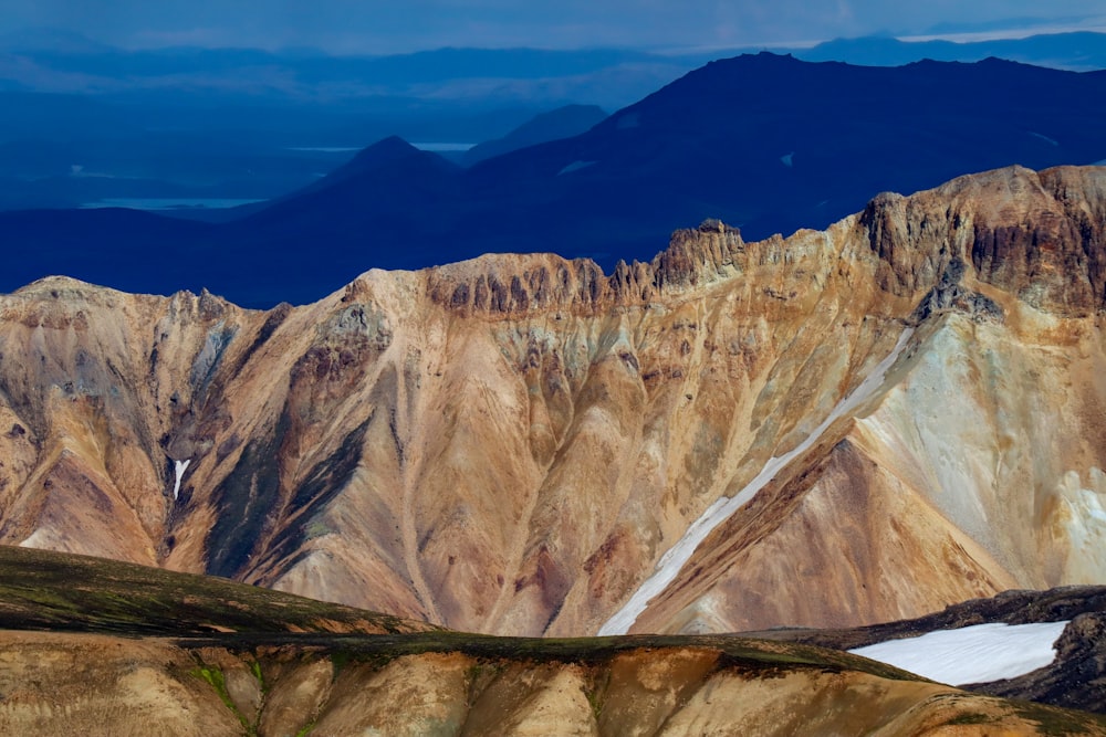 a rocky mountain with a valley below