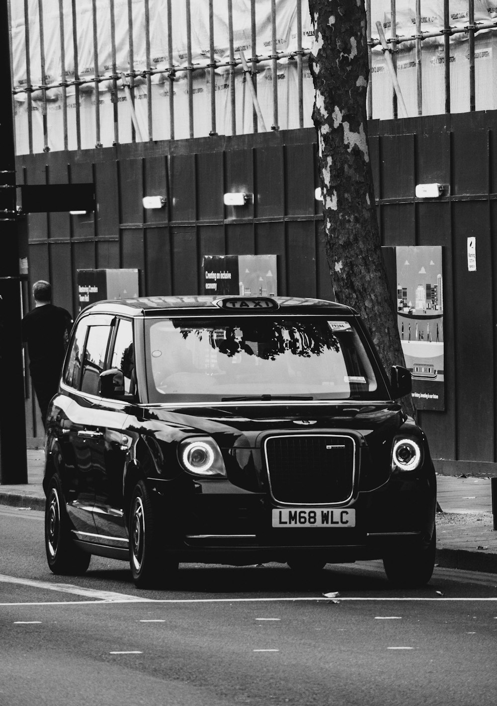 a black car parked on the side of a street