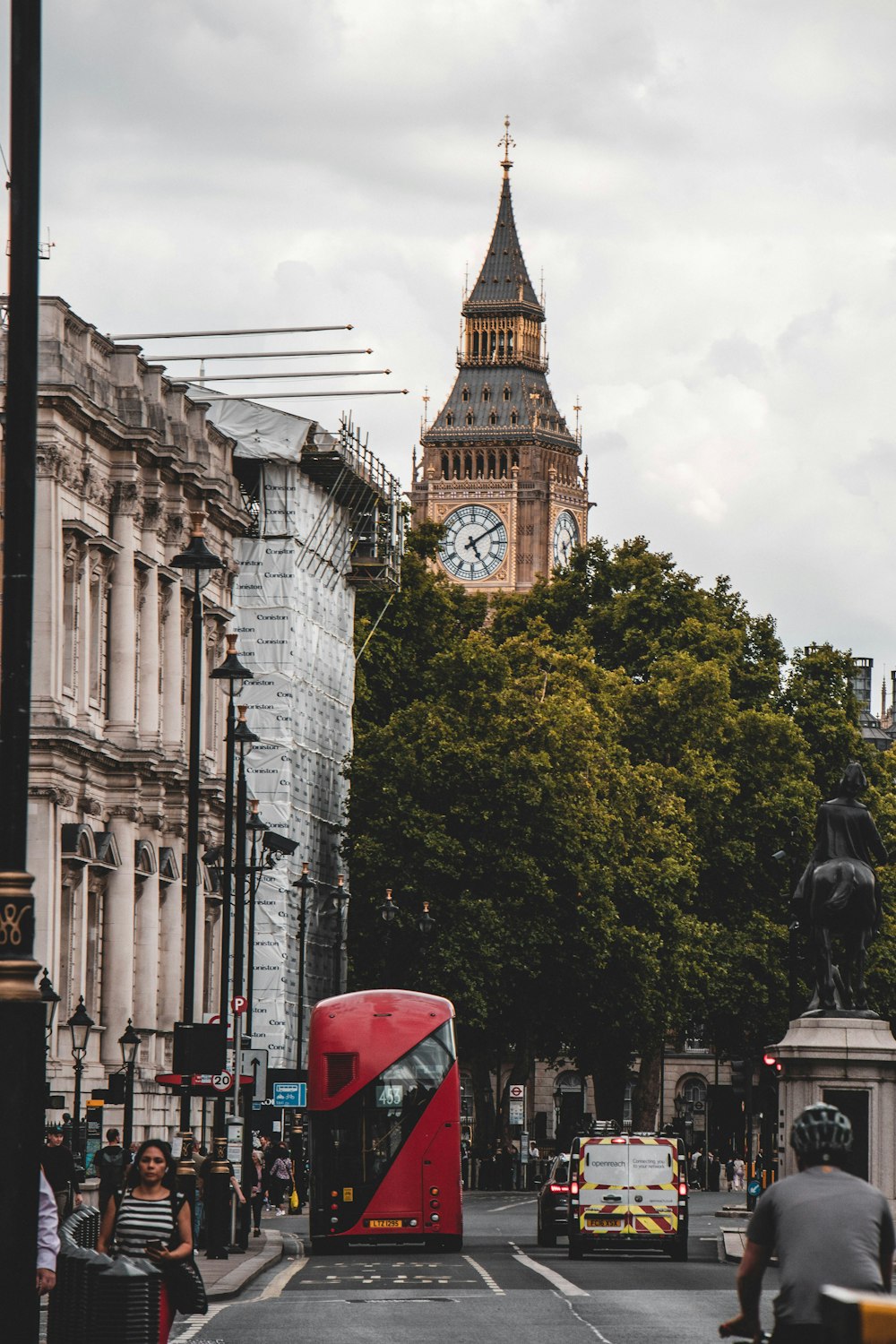 a red double decker bus on the street