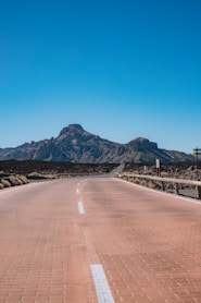 a road with a mountain in the background