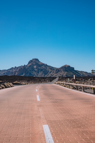 a road with a mountain in the background