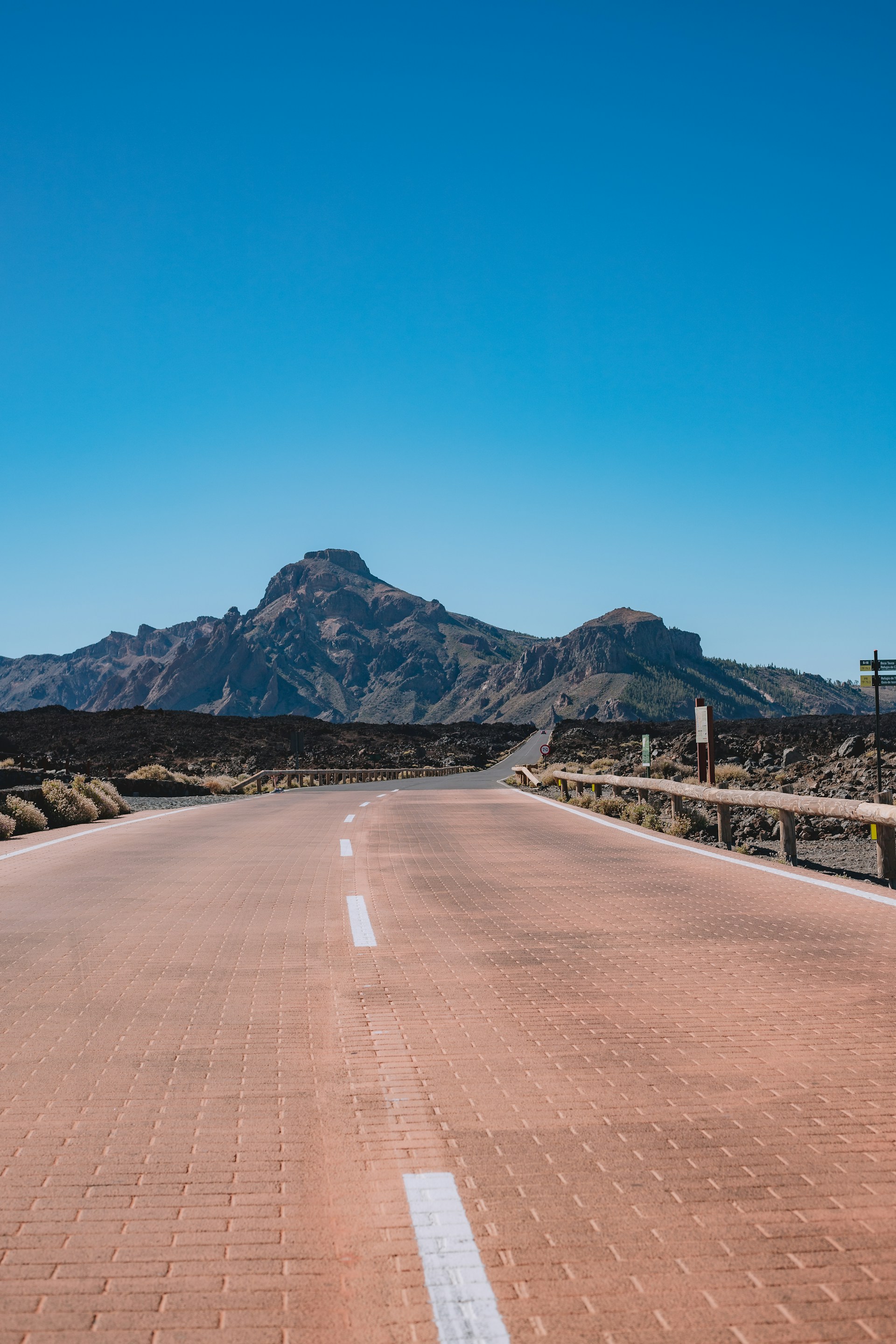 a road with a mountain in the background