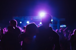 Two people enjoying a concert together, highlighting the fun of activity partners through Flexdate.