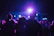 Couple enjoying a captivating live show with vibrant stage lighting in an intimate club setting.