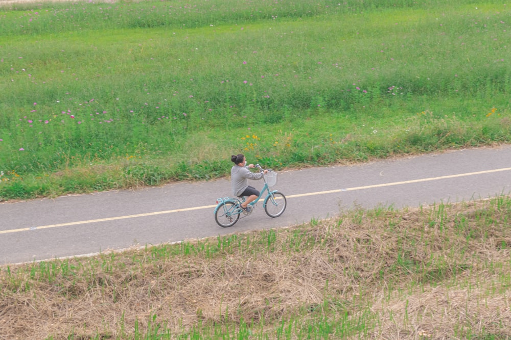 a boy riding a bicycle on a road
