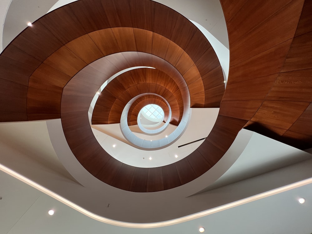 a spiral staircase with a wood ceiling
