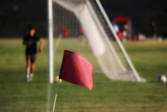 a red umbrella on a football field