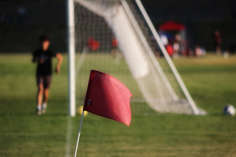a red umbrella on a football field