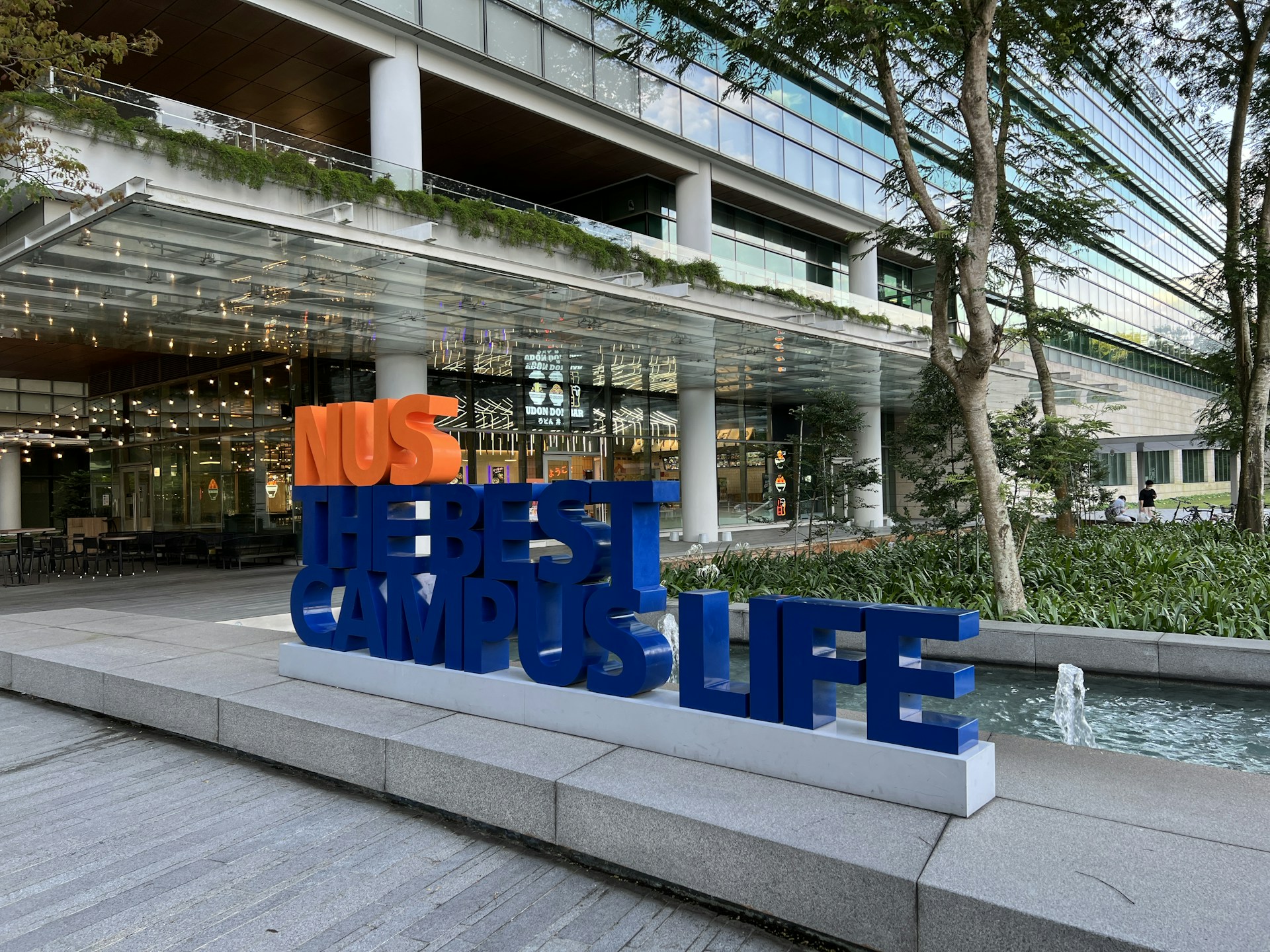 a group of blue chairs outside a building