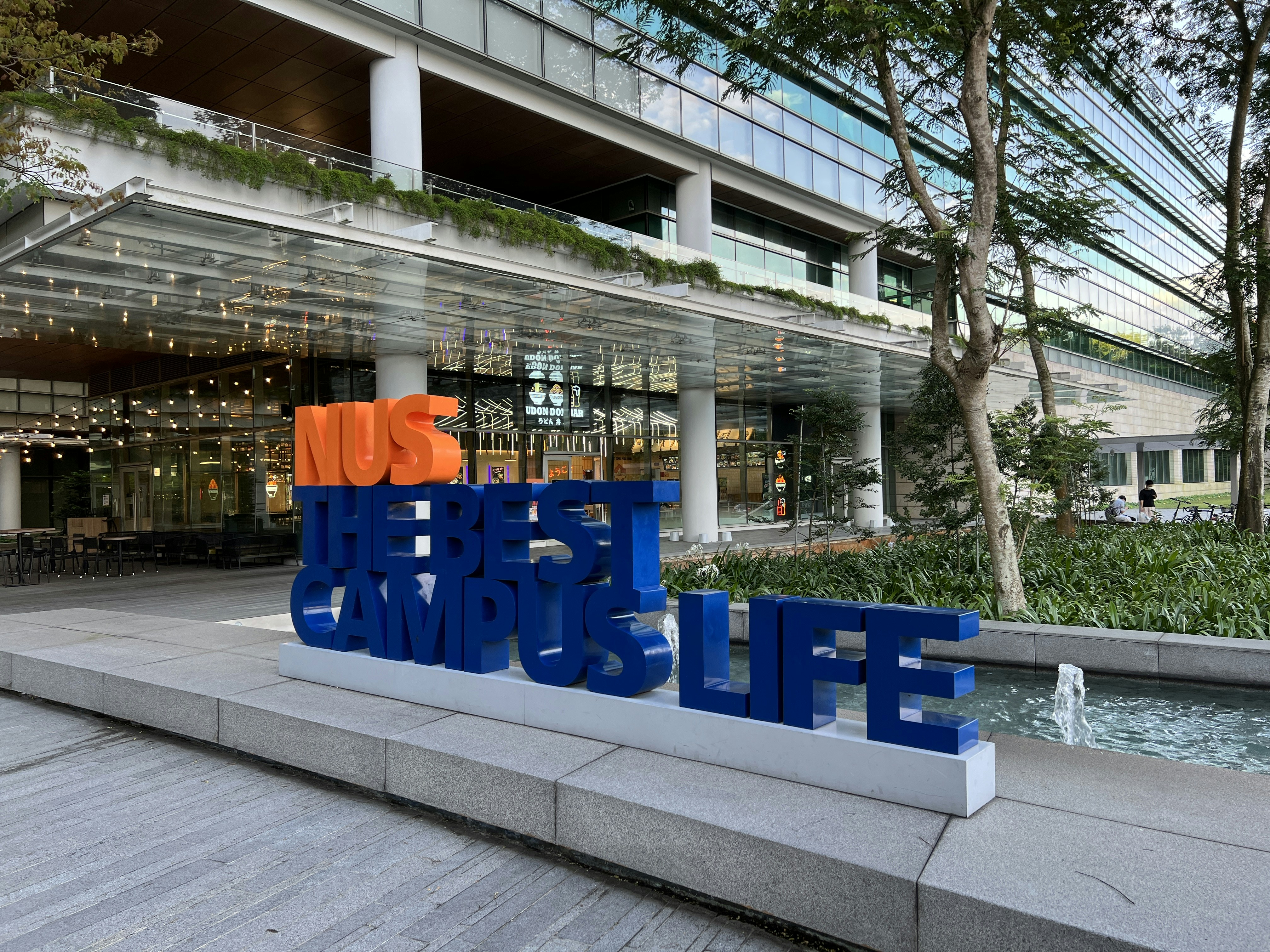 a group of blue chairs outside a building
