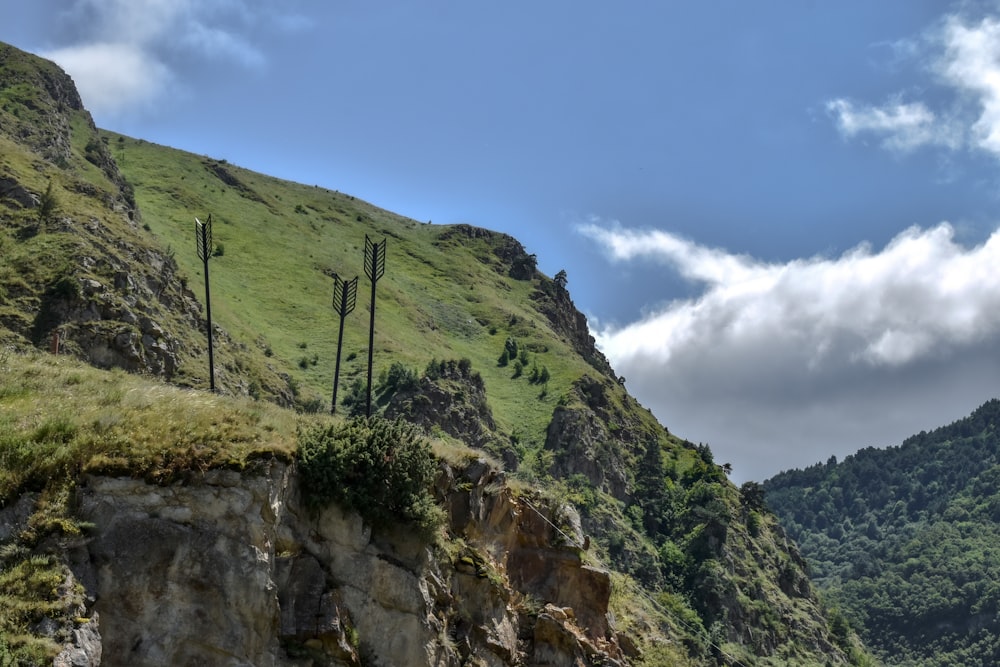 a rocky hillside with a few telephone poles on it