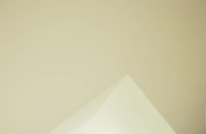 Image of a minimalist logo design printed on textured paper with natural lighting