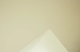 Image of a minimalist logo design printed on textured paper with natural lighting