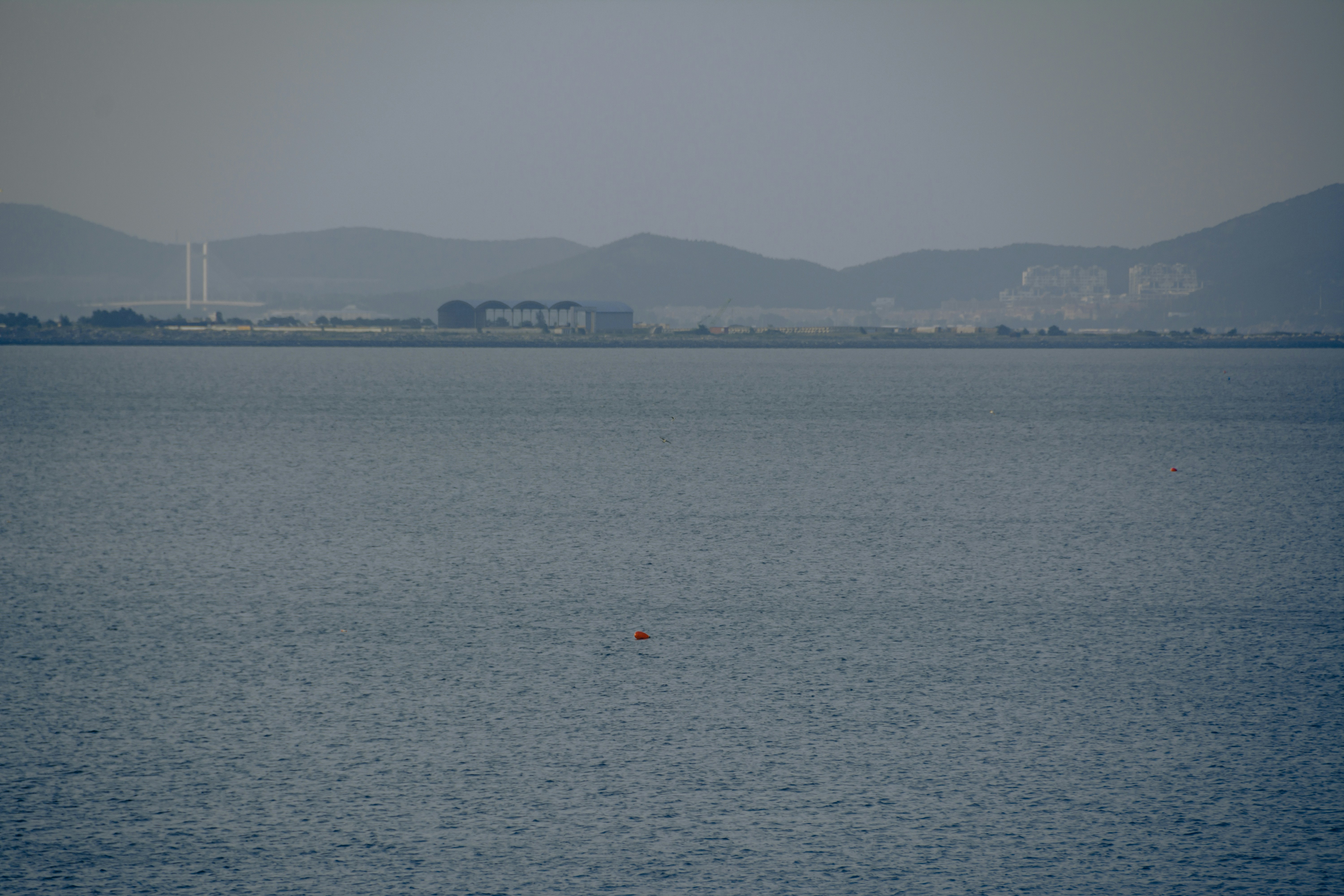 a body of water with a city in the distance