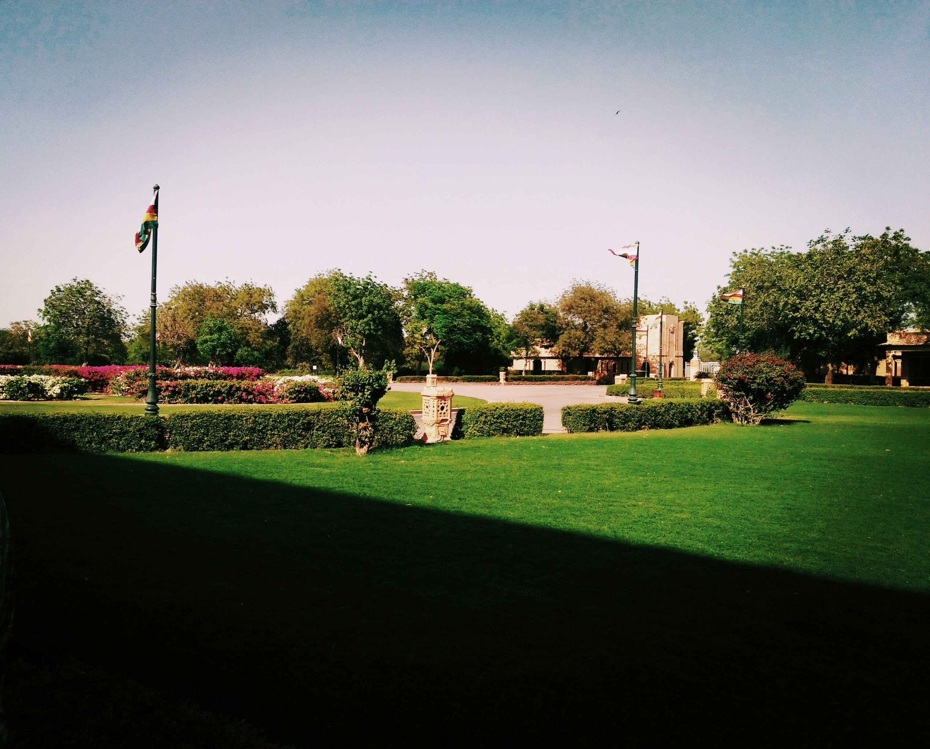 a large green lawn with a flag