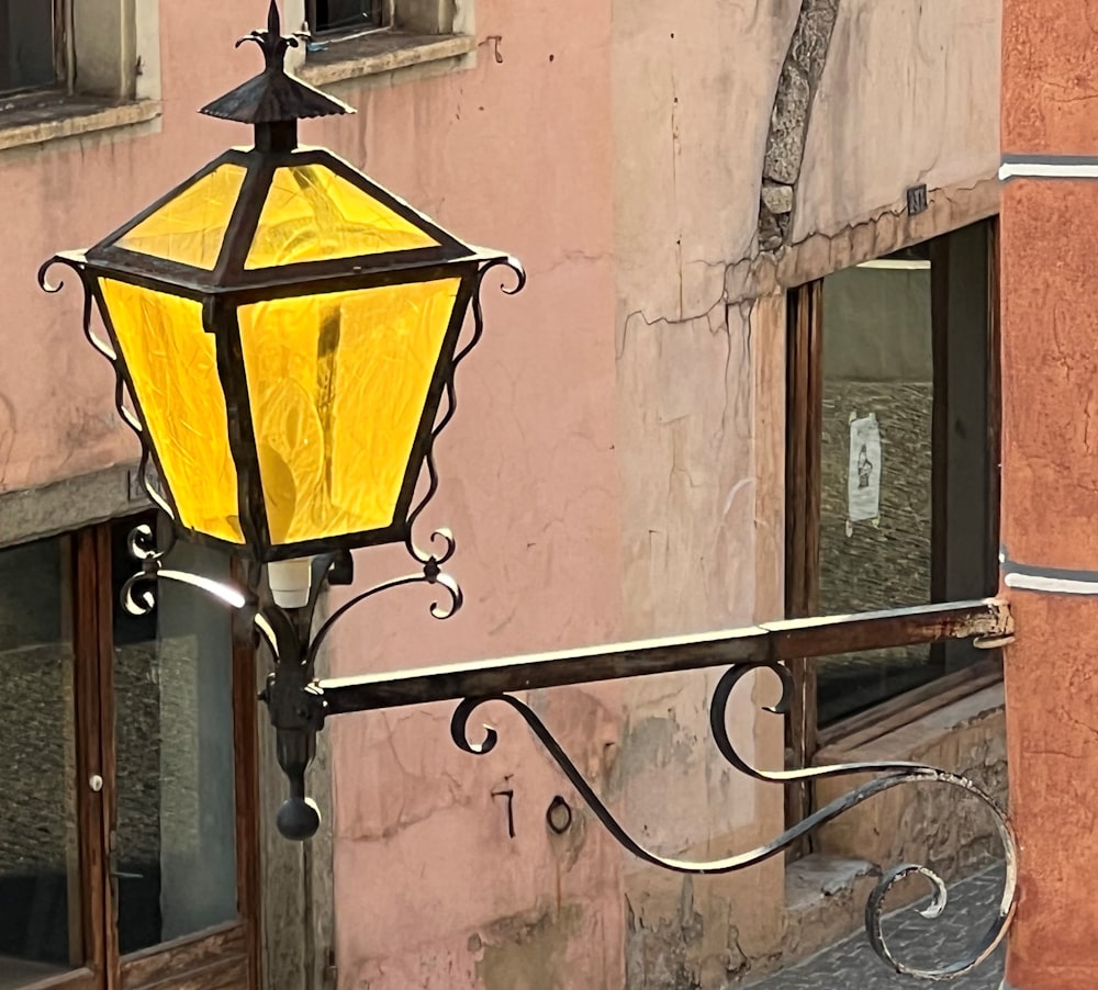 a yellow lamp on a metal railing
