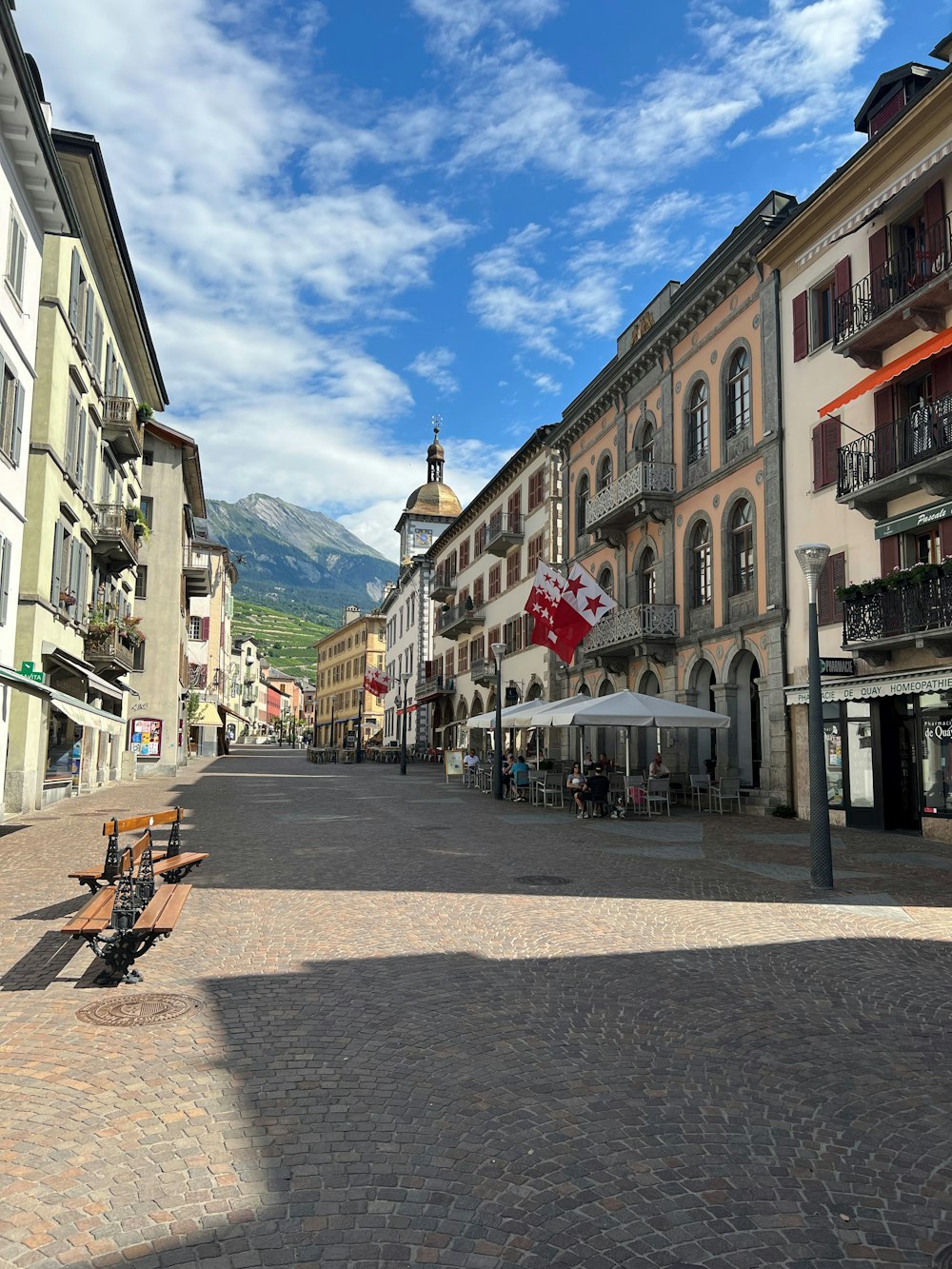 a cobblestone street with buildings on either side of it