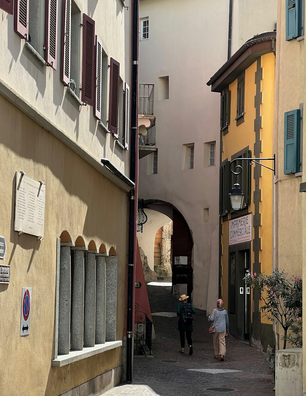 people walking down a narrow street