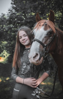 a person standing next to a horse